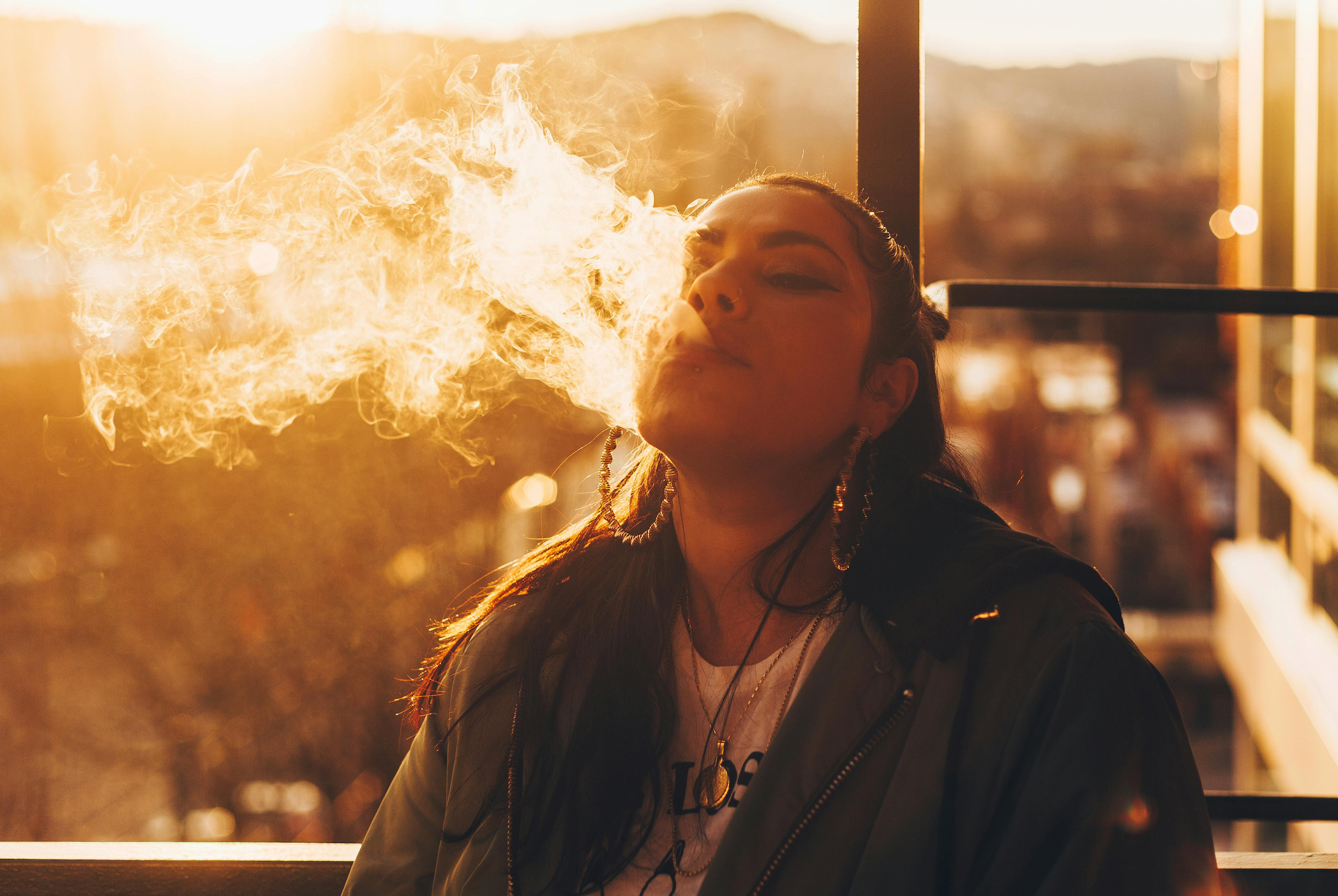 woman exhaling from a vape