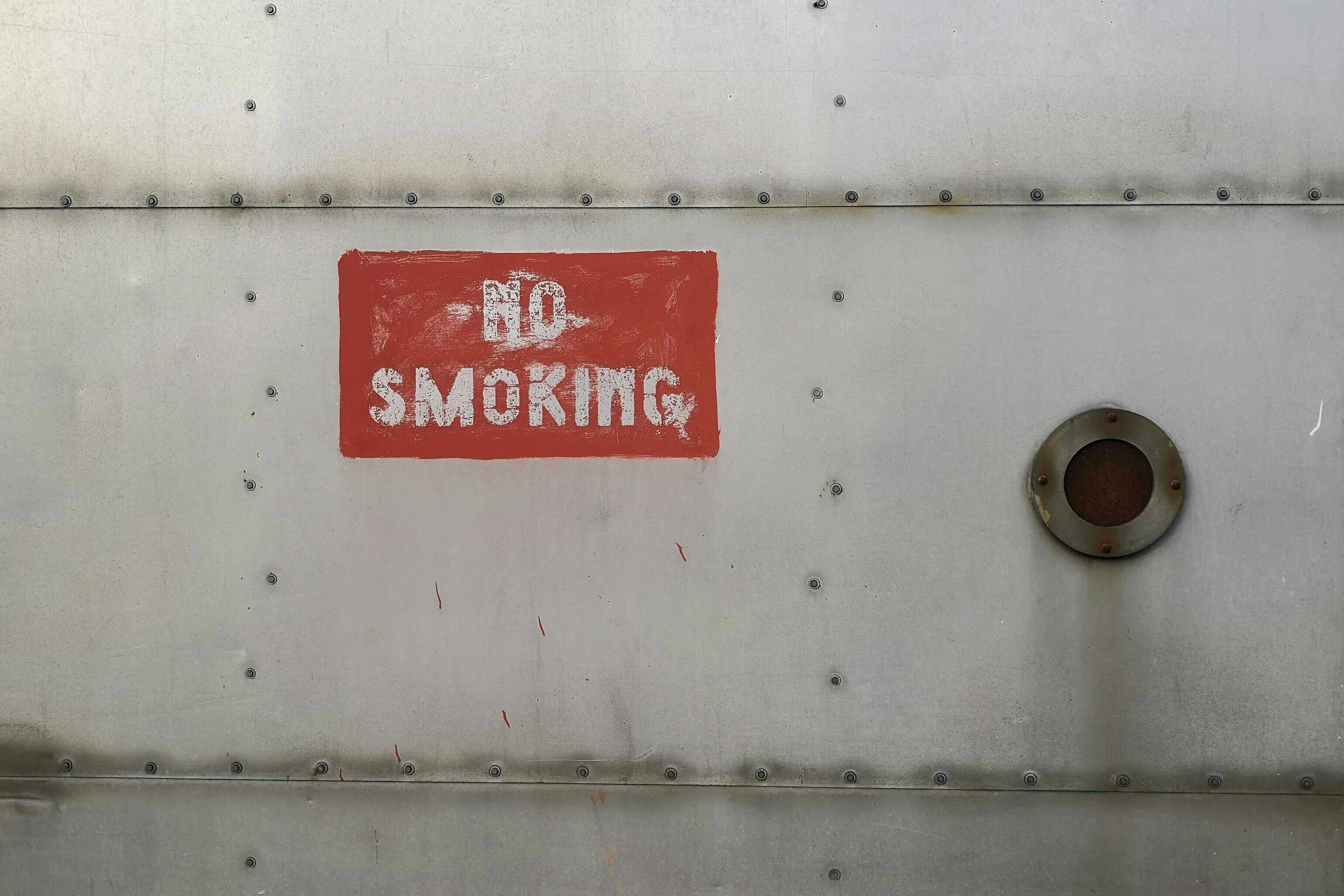 no smoking sign on a metal wall