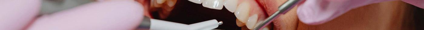close up of woman having a teeth cleaning by a dentist
