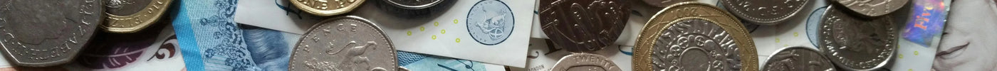stack of British pound notes and coins